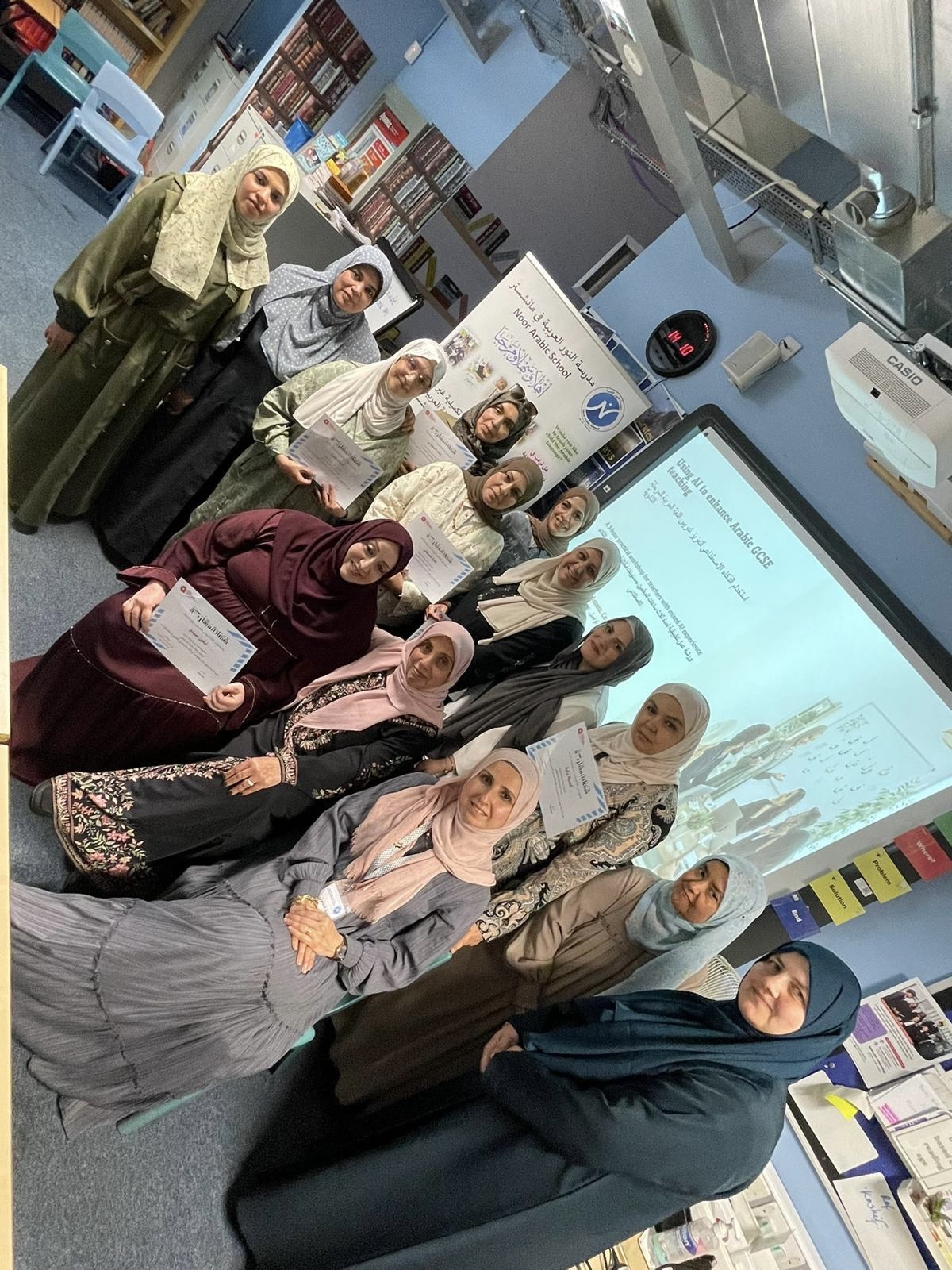 Council members holding their certificates after the May 2026 training on AI in Arabic teaching