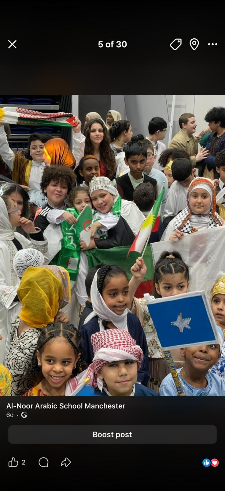 Children at the culture day, holding flags of their families' home countries